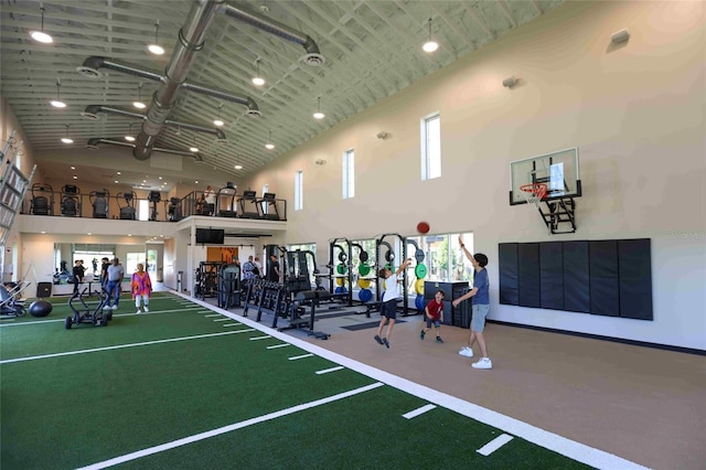 gym with high vaulted ceiling and basketball hoop