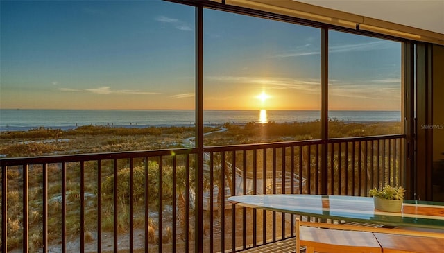 exterior space with a water view and a beach view