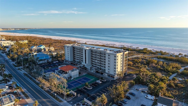 birds eye view of property with a water view and a view of the beach