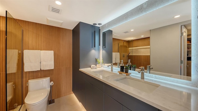 bathroom featuring vanity, toilet, tile patterned flooring, and a shower