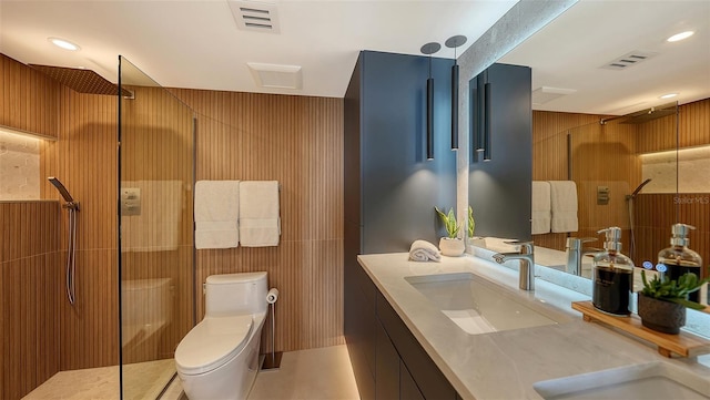 bathroom featuring vanity, walk in shower, toilet, and wood walls