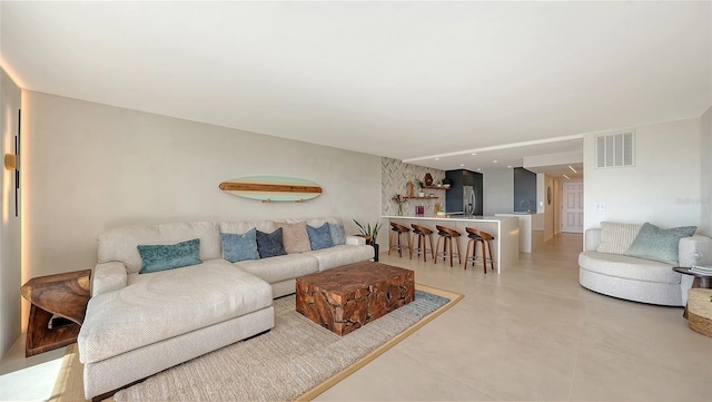 living room featuring concrete flooring