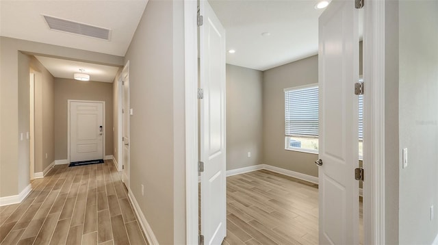 corridor featuring light hardwood / wood-style flooring