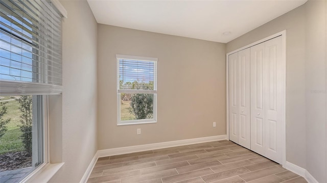 unfurnished bedroom featuring light wood-type flooring and a closet