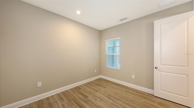 spare room featuring light hardwood / wood-style floors