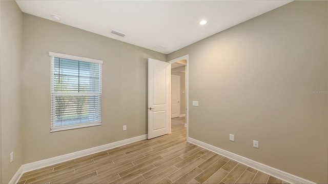 spare room with light hardwood / wood-style floors