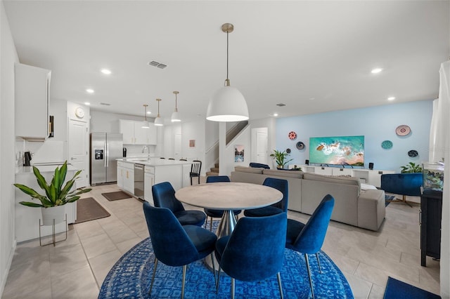 tiled dining room featuring sink