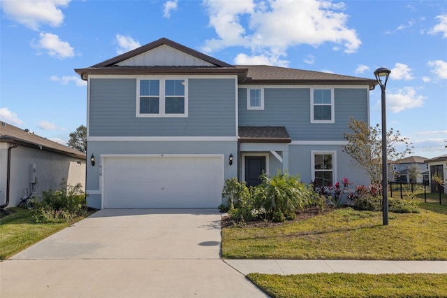 front of property featuring a front yard and a garage