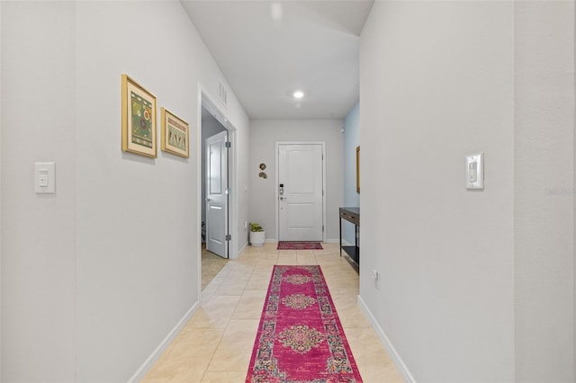 hall with light tile patterned floors