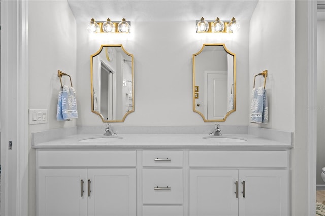 bathroom featuring toilet and vanity