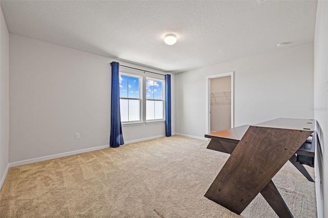 unfurnished office with a textured ceiling and light colored carpet