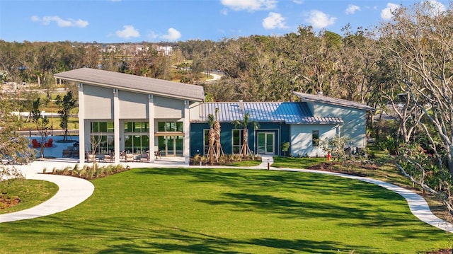 rear view of property featuring a yard and a patio