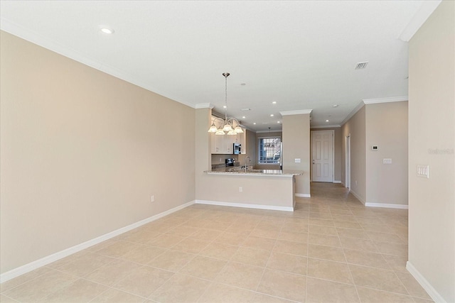 kitchen with sink, light tile patterned floors, ornamental molding, kitchen peninsula, and pendant lighting