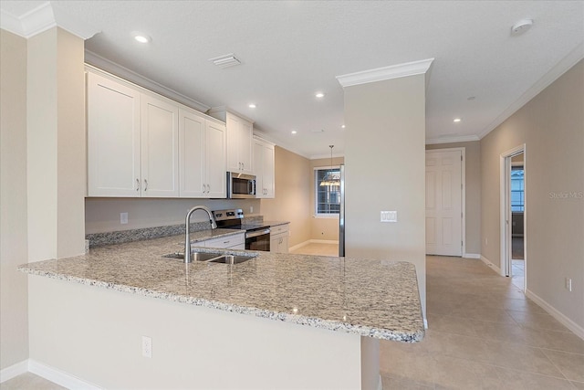 kitchen featuring sink, stainless steel appliances, light stone countertops, white cabinets, and kitchen peninsula