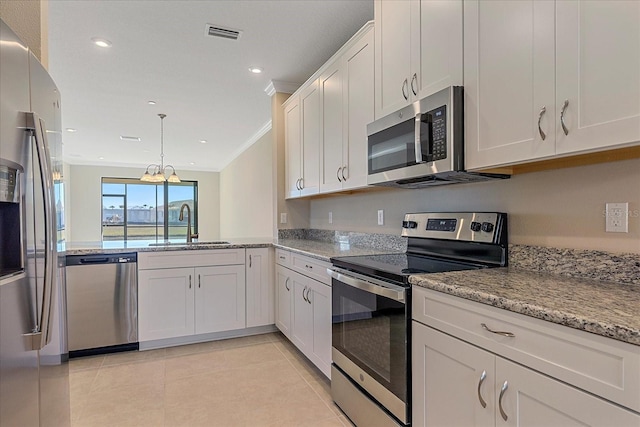 kitchen featuring appliances with stainless steel finishes, sink, white cabinets, hanging light fixtures, and ornamental molding