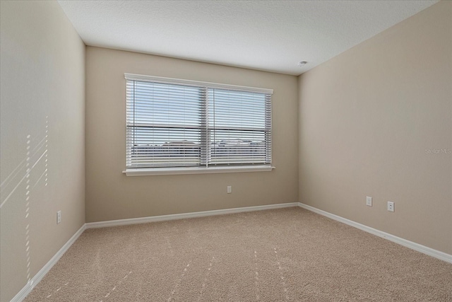 carpeted spare room featuring a textured ceiling