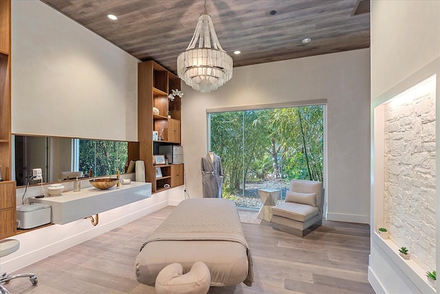 interior space featuring a notable chandelier, wooden ceiling, access to exterior, and light wood-type flooring