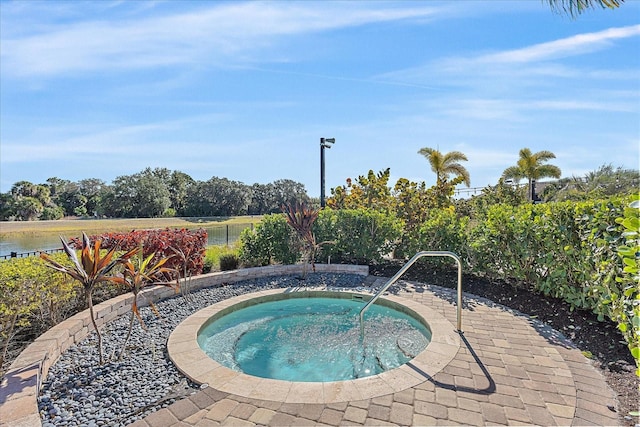 view of pool featuring a water view and an in ground hot tub