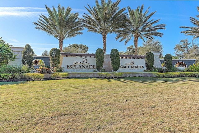 community sign featuring a lawn