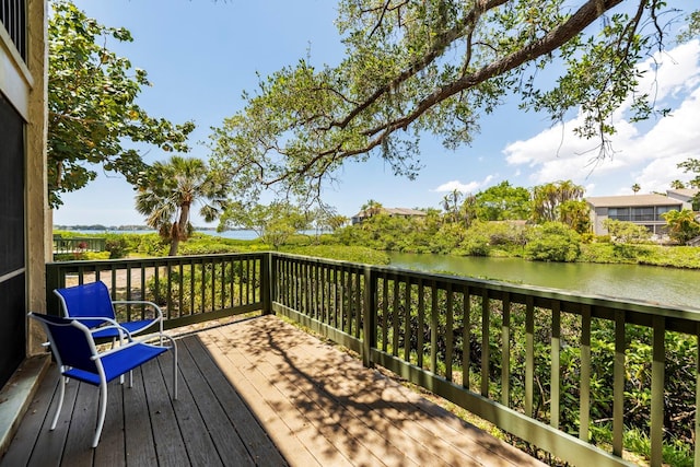 wooden terrace featuring a water view