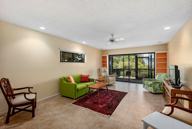 tiled living room with a textured ceiling and ceiling fan