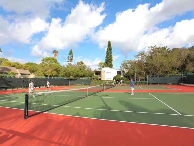 view of tennis court with basketball hoop