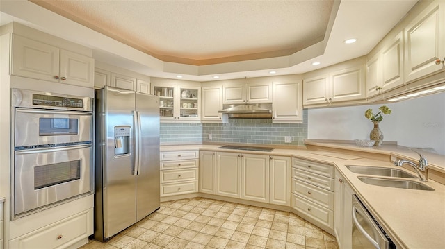 kitchen with stainless steel appliances, sink, and backsplash