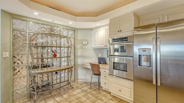 kitchen featuring stainless steel appliances and white cabinets