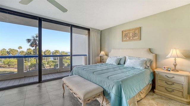 bedroom with access to exterior, a wall of windows, and ceiling fan