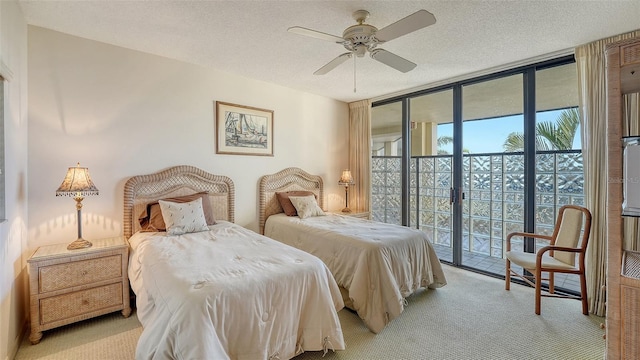 bedroom with floor to ceiling windows, a textured ceiling, access to exterior, and ceiling fan