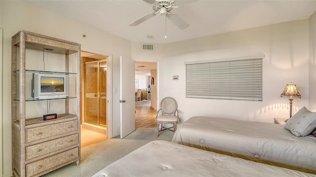 bedroom with ceiling fan and ensuite bath