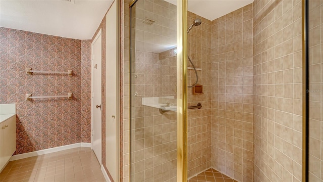 bathroom with a tile shower and tile patterned floors