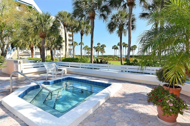 view of pool with a hot tub