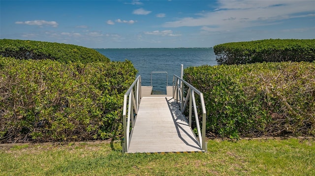 view of community with a water view and a boat dock