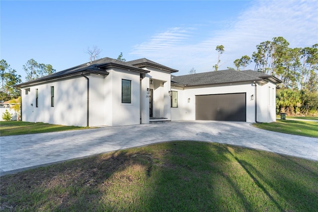 view of front of home featuring a front lawn and a garage