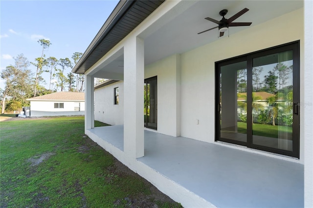 exterior space with ceiling fan and a patio area