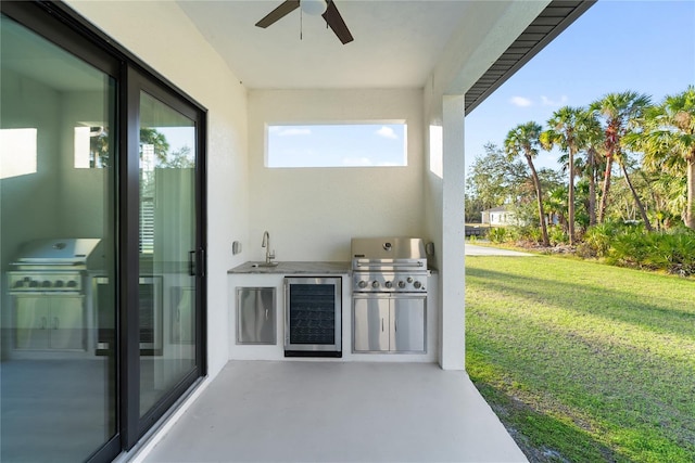 view of patio with exterior kitchen, a grill, wine cooler, sink, and ceiling fan