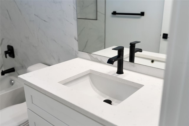 full bathroom featuring toilet, vanity, and shower / washtub combination