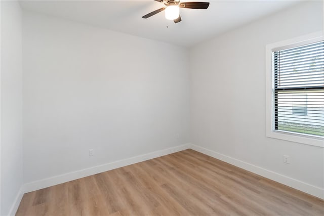 empty room featuring ceiling fan, light hardwood / wood-style flooring, and a healthy amount of sunlight