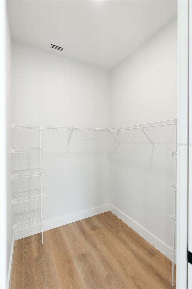 spacious closet featuring hardwood / wood-style floors