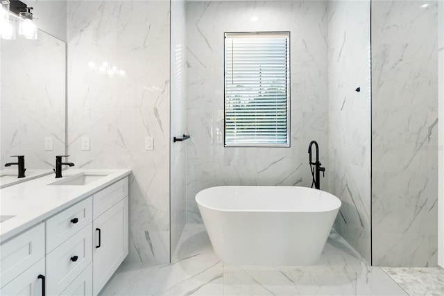 bathroom featuring a washtub and vanity