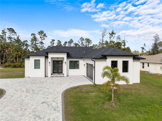 view of front facade featuring a front yard and a garage