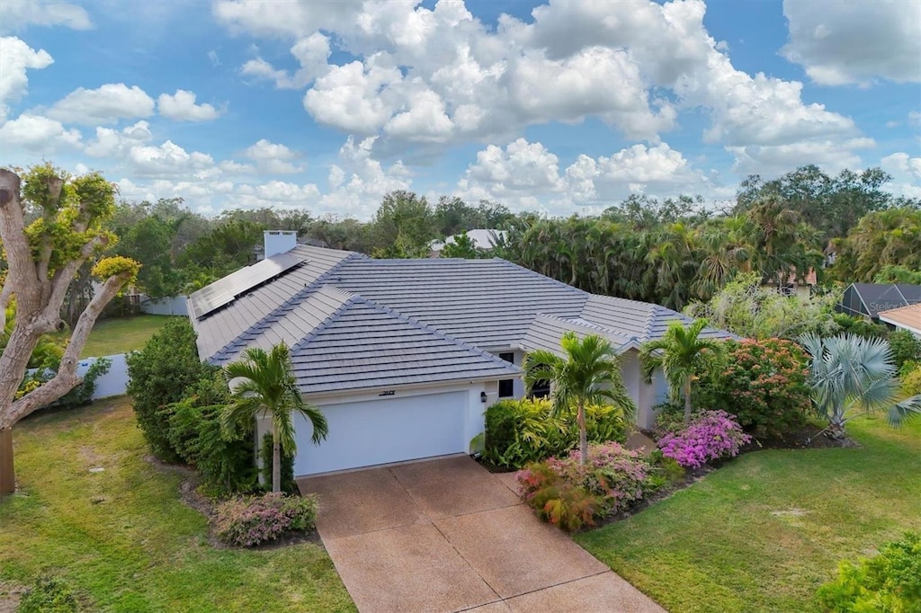 5179 Flicker Field Cir, Sarasota, FL 34231 - view of front of home with a garage and a front lawn