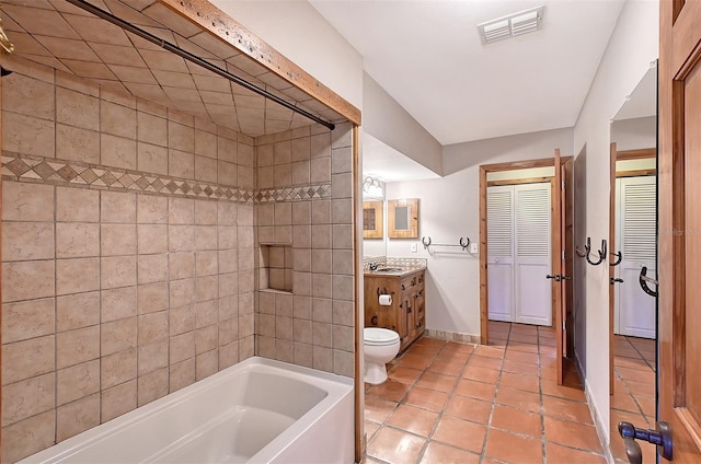 bathroom with toilet, vanity, and tile patterned flooring