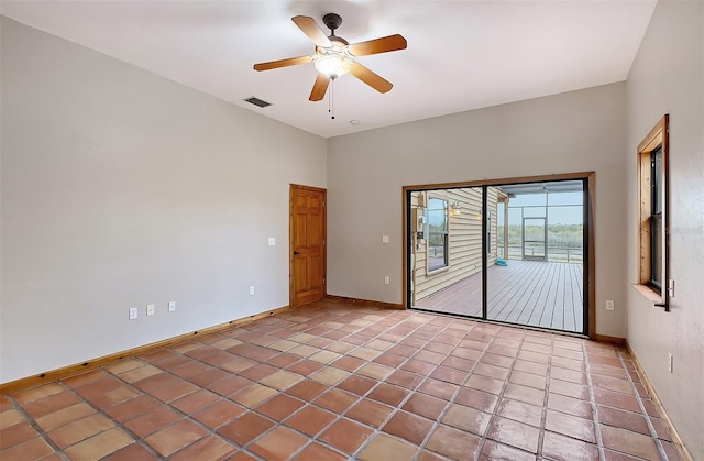 tiled empty room with ceiling fan