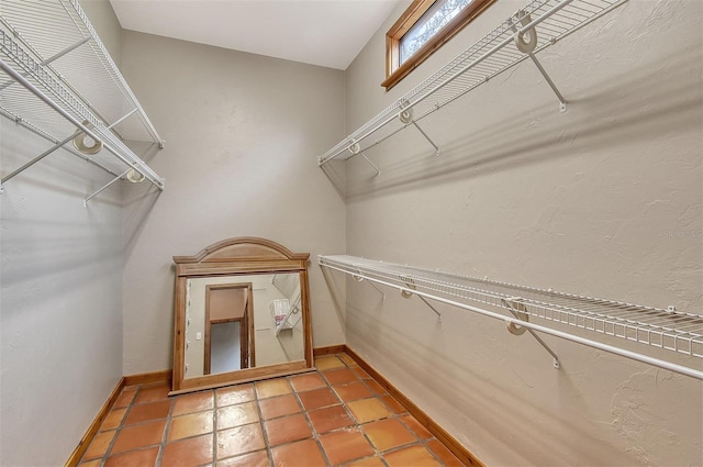 spacious closet with tile patterned floors