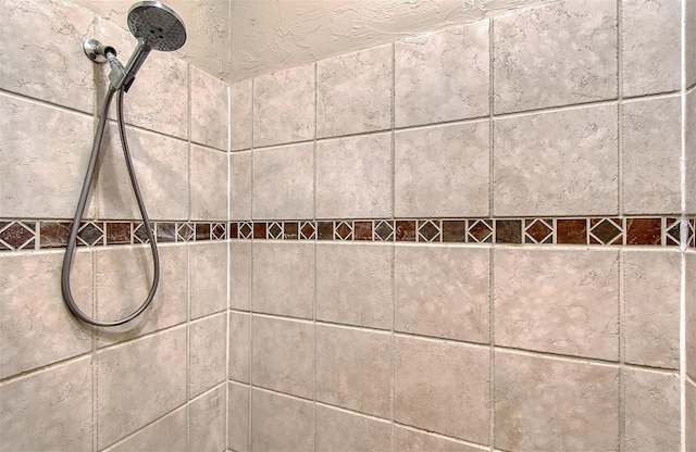 interior details with a tile shower