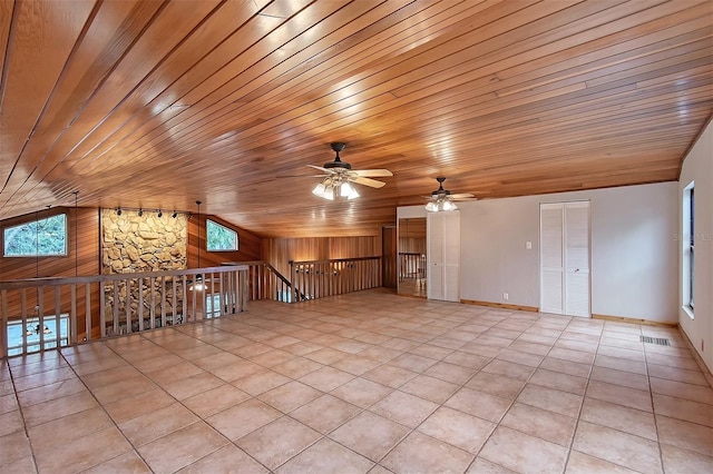 unfurnished living room with ceiling fan, light tile patterned floors, vaulted ceiling, and wooden ceiling