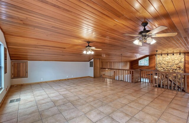 bonus room with ceiling fan, light tile patterned flooring, and wooden ceiling