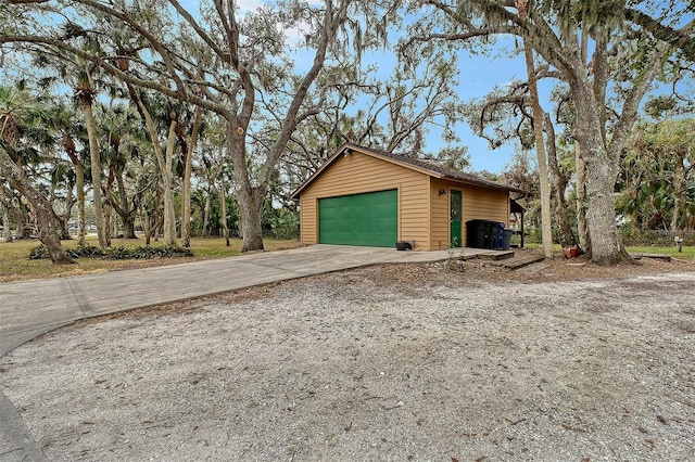 view of side of property with a garage and an outbuilding